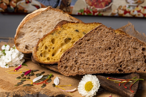 Warm artisan bread display in a modern bakery counter with sourdough loaves.
